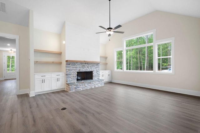150 Doris Path, Dallas, GA 30157 - unfurnished living room with vaulted ceiling, a ceiling fan, wood finished floors, baseboards, and a stone fireplace