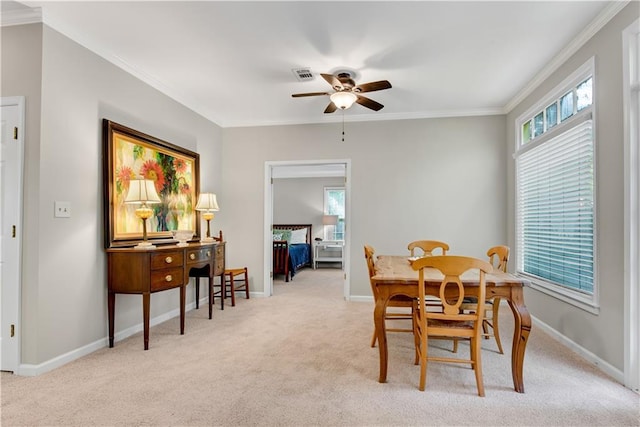 dining area featuring light carpet, plenty of natural light, ornamental molding, and baseboards