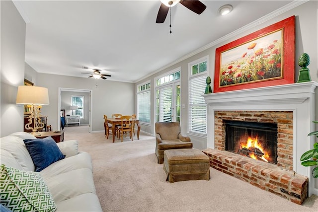 living room featuring light carpet, baseboards, ceiling fan, crown molding, and a brick fireplace