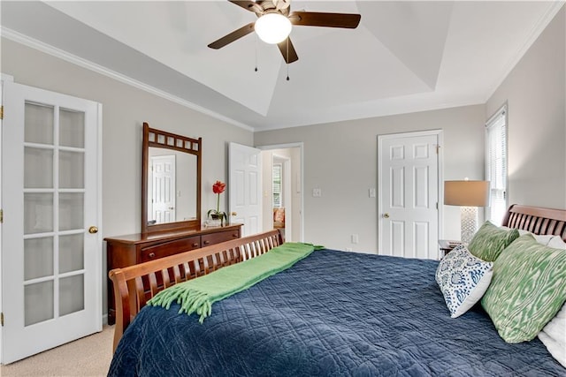 bedroom featuring carpet floors, a raised ceiling, crown molding, and ceiling fan