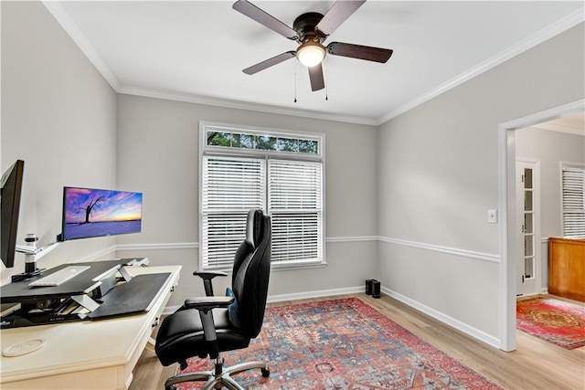 home office with ornamental molding, light wood-style flooring, and baseboards