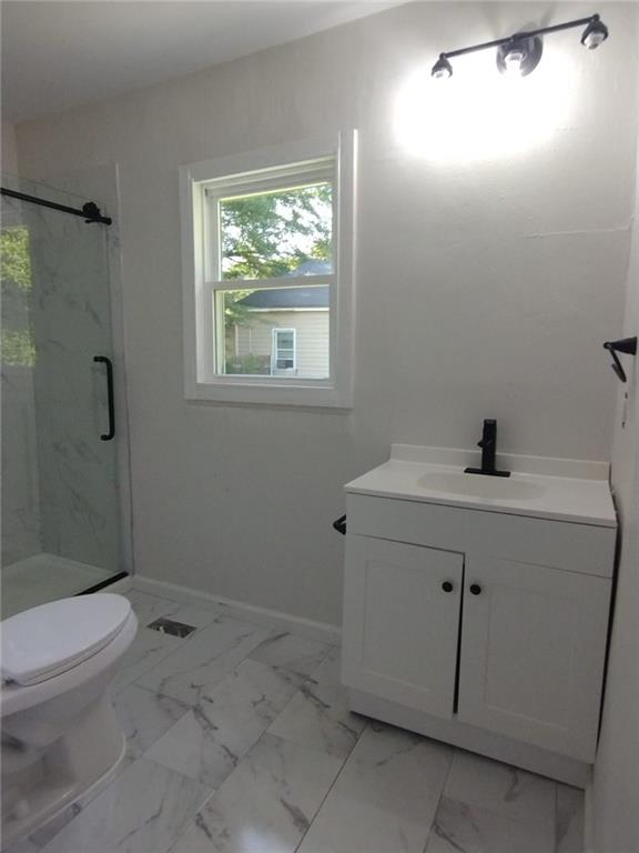 747 Bowman St, Macon, GA 31217 - full bath with vanity, a marble finish shower, and marble look tiles