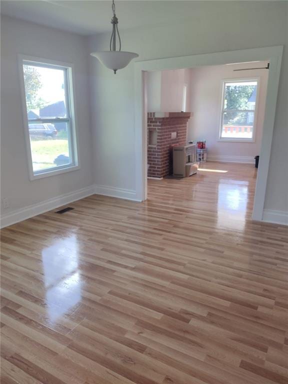 747 Bowman St, Macon, GA 31217 - unfurnished living room featuring baseboards and light wood-style floors