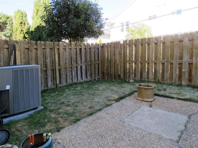 view of yard featuring cooling unit and a patio area