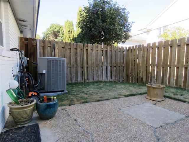 view of yard featuring central AC and a patio