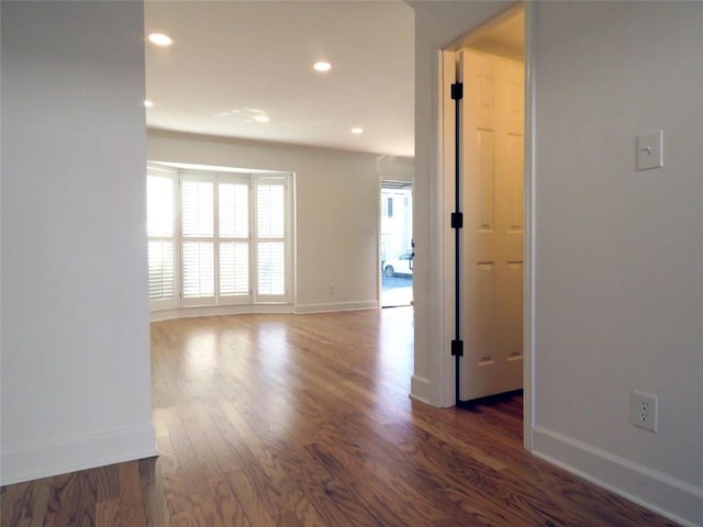 spare room with dark wood-type flooring