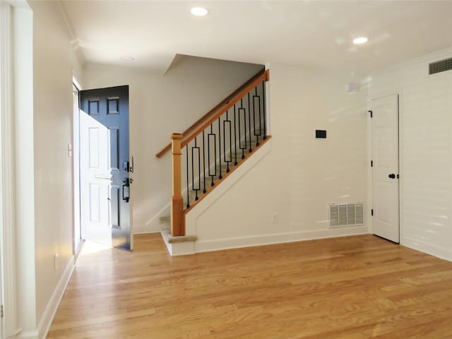 entryway with light hardwood / wood-style floors and ornamental molding