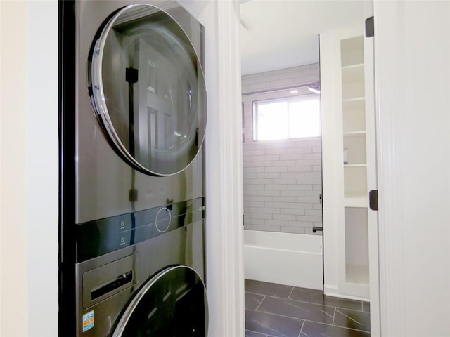 washroom with stacked washer and dryer