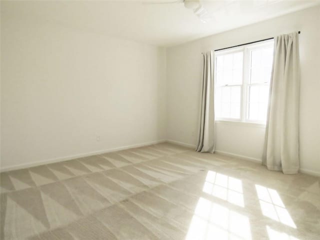 unfurnished room with light carpet