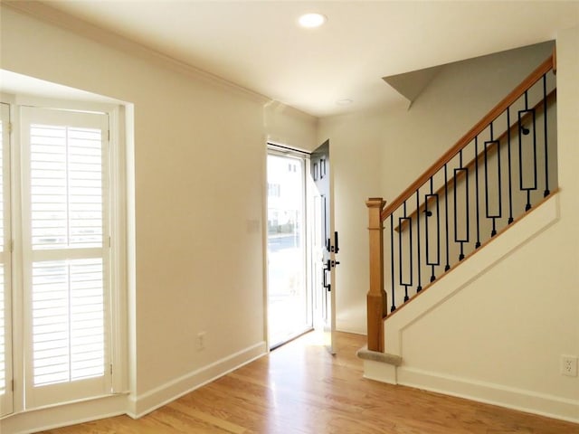 foyer featuring light hardwood / wood-style floors and ornamental molding