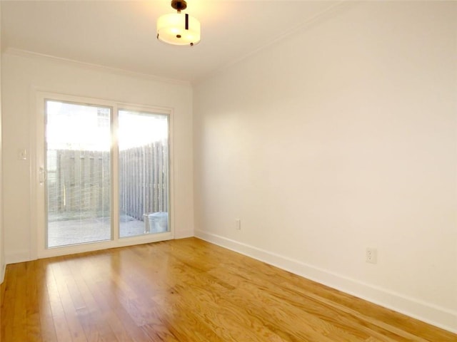 empty room with crown molding and hardwood / wood-style floors