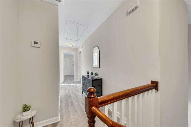 corridor with light hardwood / wood-style flooring