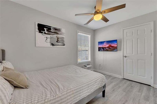 bedroom with ceiling fan and light hardwood / wood-style flooring