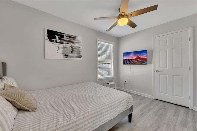 bedroom with ceiling fan and light hardwood / wood-style flooring