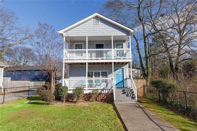 view of front of property with a balcony, a porch, and a front lawn