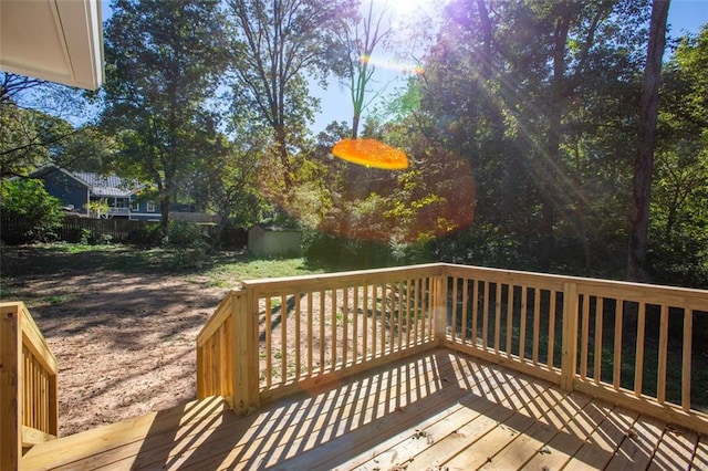 wooden deck with an outbuilding and a shed