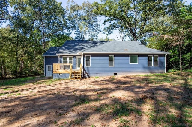 single story home featuring a wooden deck