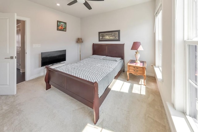 carpeted bedroom with multiple windows and ceiling fan