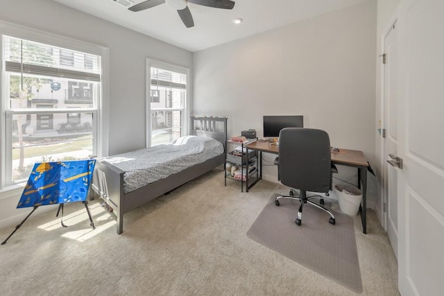 bedroom featuring ceiling fan and light carpet