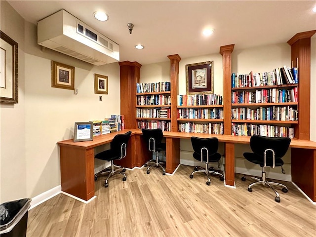 home office featuring built in desk and light wood-type flooring