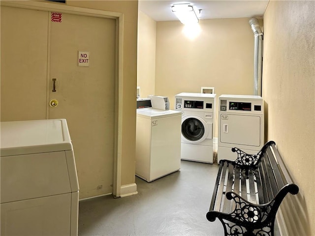 washroom with washing machine and clothes dryer