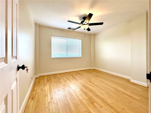 spare room featuring ceiling fan and light wood-type flooring