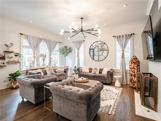 living room with a notable chandelier, dark wood-type flooring, and crown molding