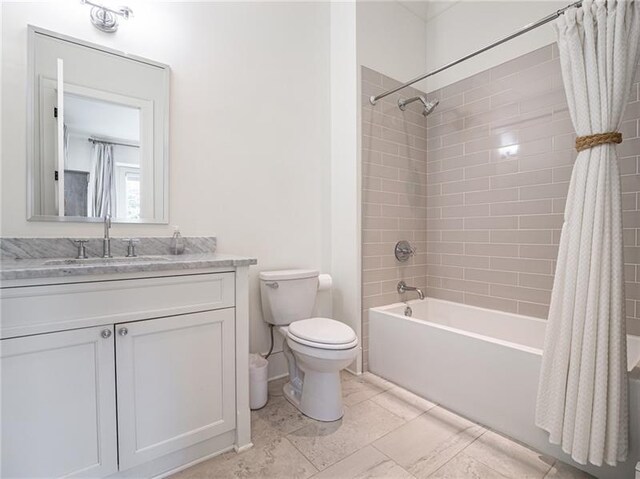 full bathroom with tile patterned floors, vanity, toilet, and shower / bath combination with curtain