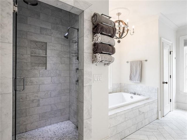 bathroom featuring a notable chandelier, shower with separate bathtub, and ornamental molding