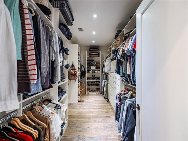 walk in closet with light wood-type flooring