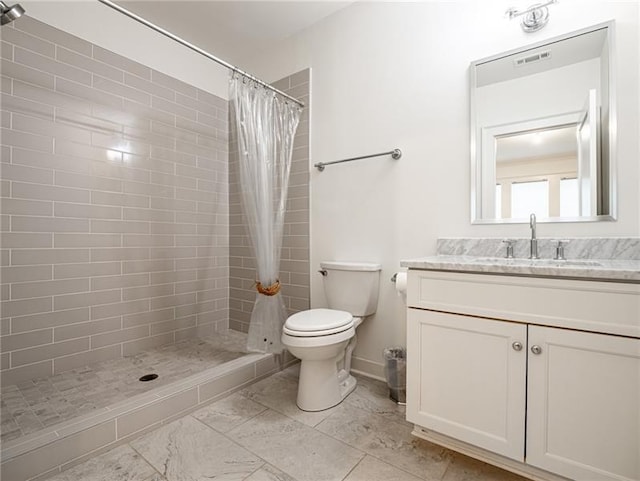 bathroom with curtained shower, toilet, tile patterned floors, and vanity