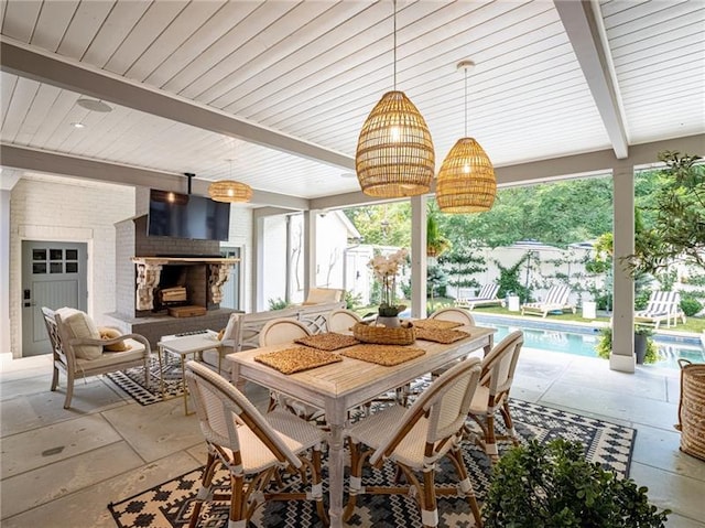 dining area featuring beam ceiling and plenty of natural light