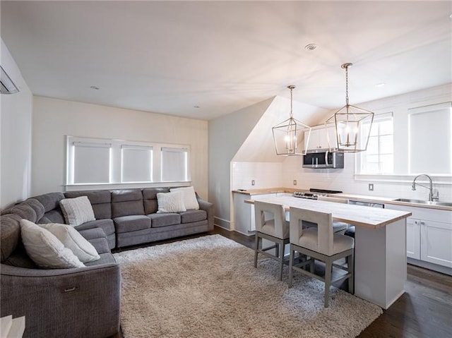 living room with wood-type flooring, sink, and a chandelier