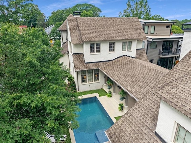 back of house featuring a balcony and a patio area