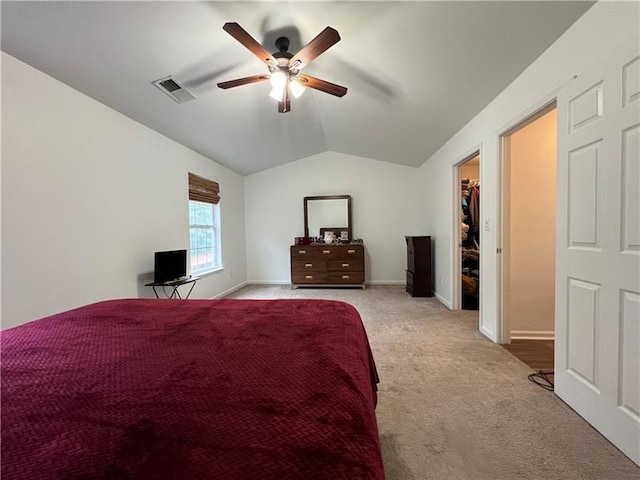 carpeted bedroom featuring ceiling fan and vaulted ceiling