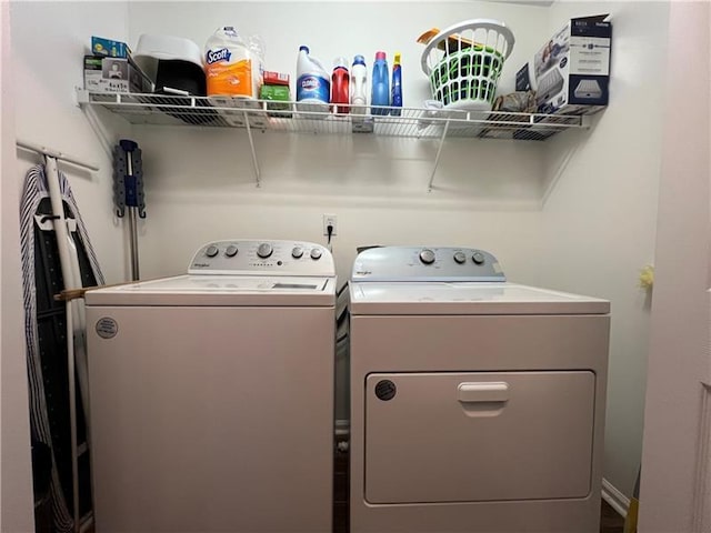 clothes washing area featuring separate washer and dryer