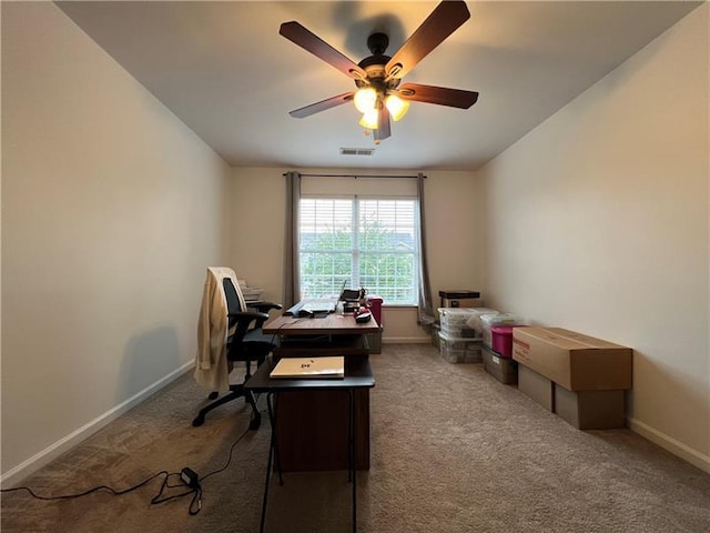 carpeted office with ceiling fan