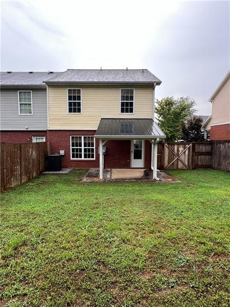 rear view of house featuring a yard, a patio area, and central air condition unit