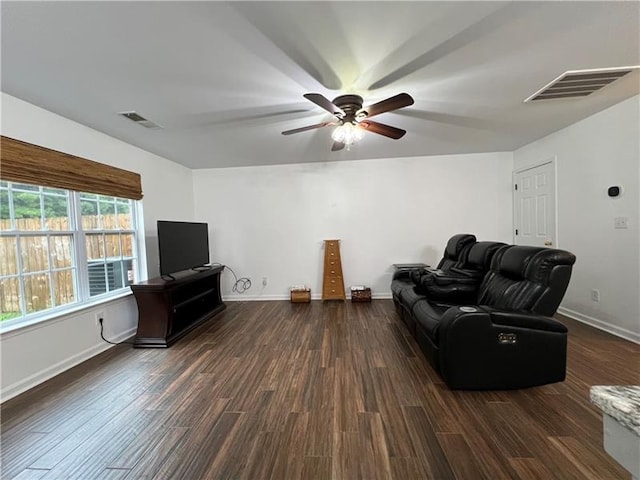 living room with dark wood-type flooring and ceiling fan