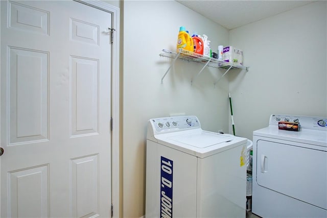 washroom with laundry area and washer and dryer