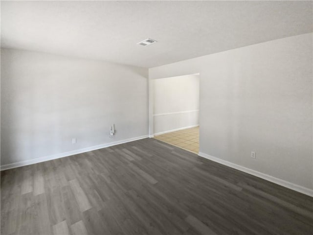 spare room with dark hardwood / wood-style floors