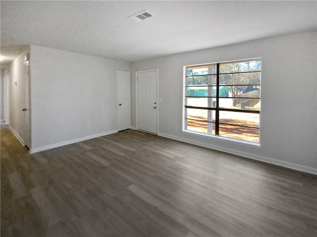 empty room featuring dark hardwood / wood-style flooring