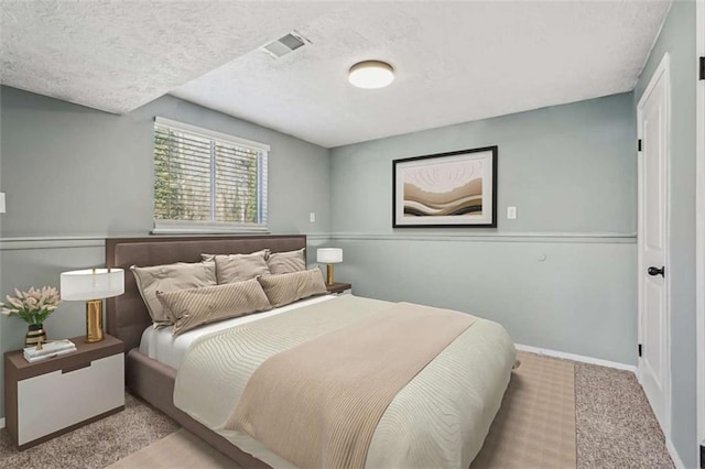 carpeted bedroom featuring a textured ceiling