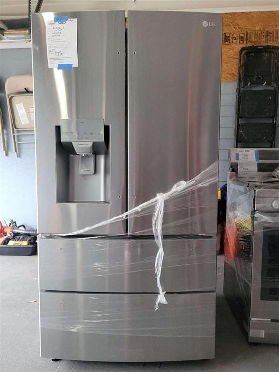 interior details featuring stainless steel fridge with ice dispenser