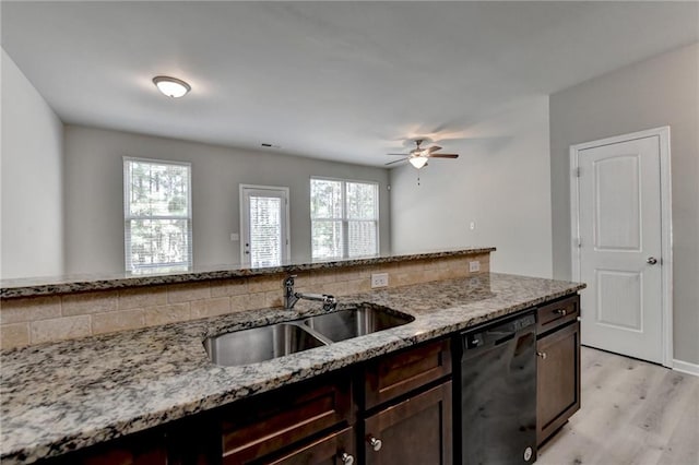 kitchen featuring dishwasher, light wood-type flooring, ceiling fan, tasteful backsplash, and light stone counters