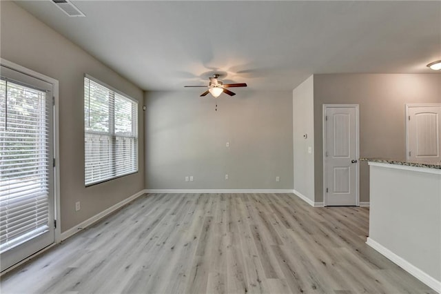 spare room with light hardwood / wood-style flooring and ceiling fan