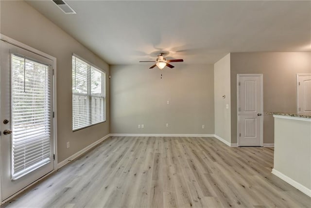 spare room featuring ceiling fan and light hardwood / wood-style floors