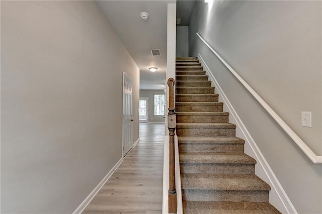 stairway featuring hardwood / wood-style floors