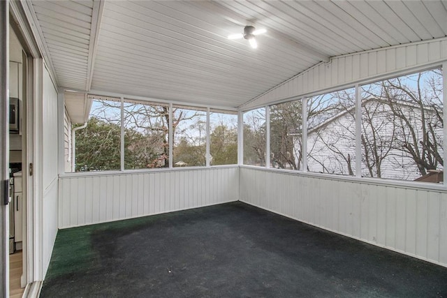 unfurnished sunroom with plenty of natural light and vaulted ceiling