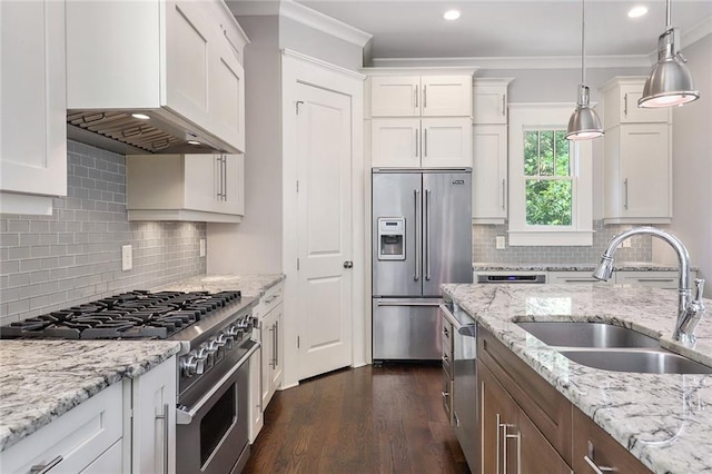 kitchen featuring crown molding, hanging light fixtures, dark hardwood / wood-style flooring, high end appliances, and white cabinetry